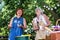 Two elderly woman bonding in backyard making barbeque and having great friendship