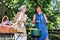 Two elderly woman bonding in backyard making barbeque and having great friendship
