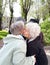 Two elderly women embrace & kiss at parting