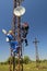 Two electricians install 4G telecommunications antenna system