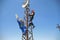 Two electricians install 5G antenna system on the lamppost