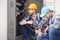 Two electricians near distribution board indoors