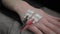 Two electronic sensors on a female hand, red and black