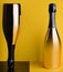 two elegant bottles of champagne on a yellow-black background