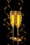 Two elegant perfect glasses filled with carbonated drink or sparkling champagne with gold serpentines on a black background