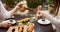 Two elegant women eating sushi set with wasabi and ginger.