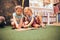 Two elementary schoolgirls solving puzzles and riddles in school library. Students learning from books. Back to school