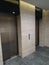 Two elevators in the hotel lobby. The iron door of the Elevator
