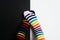 Two embarrassing legs in colorful striped socks on black and white background. Negative pair love concept with two people with
