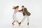 Two emotional dancers in vintage style clothes dancing swing dance, rock-and-roll or lindy hop isolated on white