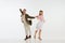 Two emotional dancers in vintage style clothes dancing swing dance, rock-and-roll or lindy hop  on white