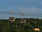 Two empty cabins of a cableway meat each other in town Koblenz, Germany with evening sun reflected in the glass window.