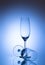 Two empty champagne glass on blue background. Luxury drink glasses in blue lights