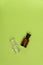 Two empty glass bottles on green background. Perfume, medicine, chemistry background.