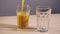 Two empty glass filled refresh orange juice slowmotion white background closeup