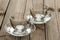 Two empty glass teacups on wooden background