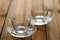 Two empty glass teacups on wooden background selective focus