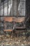 Two empty old wooden chairs on an autumn street