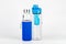 Two empty sport travel water bottles on white, one plastic with fruit infuser, one glass bottle. Pair of stylish water bottles