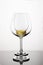 Two empty wineglasses on diffision with yellow cork inside is on a table in a white background. abstract composition with