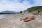 Two empty wooden sun loungers stand on the Katun river coast