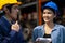 Two engineer or manager wearing safety helmet standing in the automotive part warehouse. Woman looking at man and smile. Team work