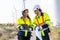 Two engineers caucasian man and woman in hardhat and goggles talk about system installation and walking to verify that a wind