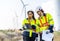 Two engineers caucasian man and woman in hardhat and goggles talk about system installation and walking to verify that a wind