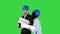 Two engineers in hardhat walk discuss blueprint Young diverse team of architects designers speaking on a Green Screen