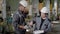 Two engineers are inspecting sample of metal detail in a workshop, one man is touching surface