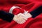 Two entrepreneur handshake with Turkey flag