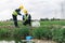 Two Environmental Engineers Inspect Water Quality and Take Water Samples Notes in The Field Near Farmland, Natural Water Sources