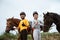 two equestrian athletes ride horses and start training