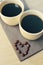 Two espresso coffees in small white cups with heart shape