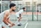 Two ethnic tennis players holding rackets and ready to play court game. Serious, focused athletes together in stance