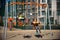 Two European boys swing on a swing in the summer holidays. Children have fun outdoors