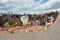 Two excavators are sorting through the rubble of buildings destroyed for dismantling