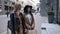 Two excited elegant women looking in shop window