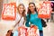 Two Excited Female Shoppers With Sale Bags In Mall