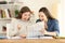 Two excited students reading a newspaper