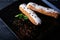 Two exquisite cream dessert eclair with fresh mint leaves