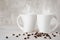 Two extraordinary white coffee cups on wooden table