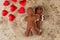 Two fabric gingerbread with hearts on wooden texture, funny love story of valentines day