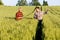 Two farmers in a field examining wheat crop.