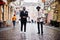 Two fashion black men walking on street. Fashionable portrait of african american male models. Wear suit, coat and hat