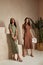 Two fashion model brunette hair wear green  brown dots silk dress sandals shoes accessory clothes date party walk interior journey