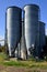 Two feed silos on a small ranch.