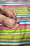 Two feet on striped towel