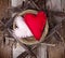 Two felt hearts in a wooden nest