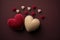 Two felted cute beige and red pastel romantic hearts on a deep red background with copy space, Vintage valentine\\\'s day or